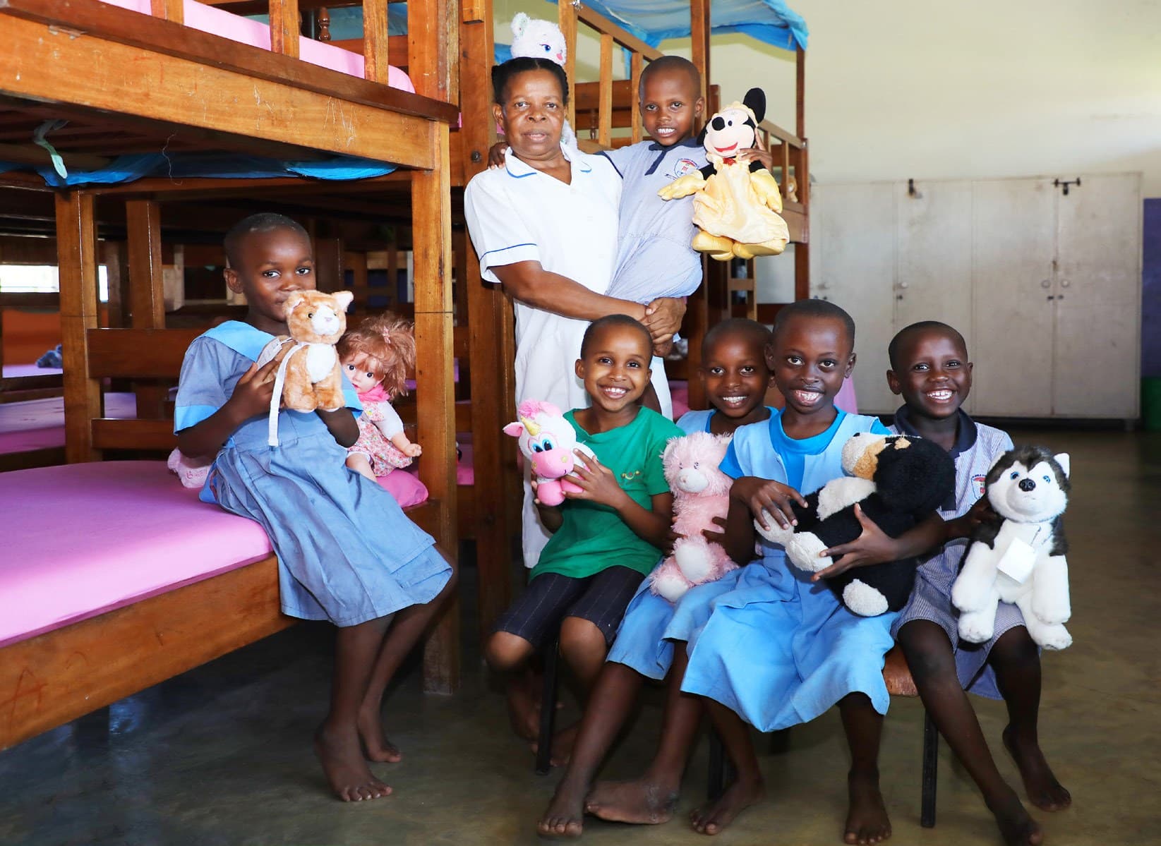 A caregiver at Wema Centre tending to children in the dormitory