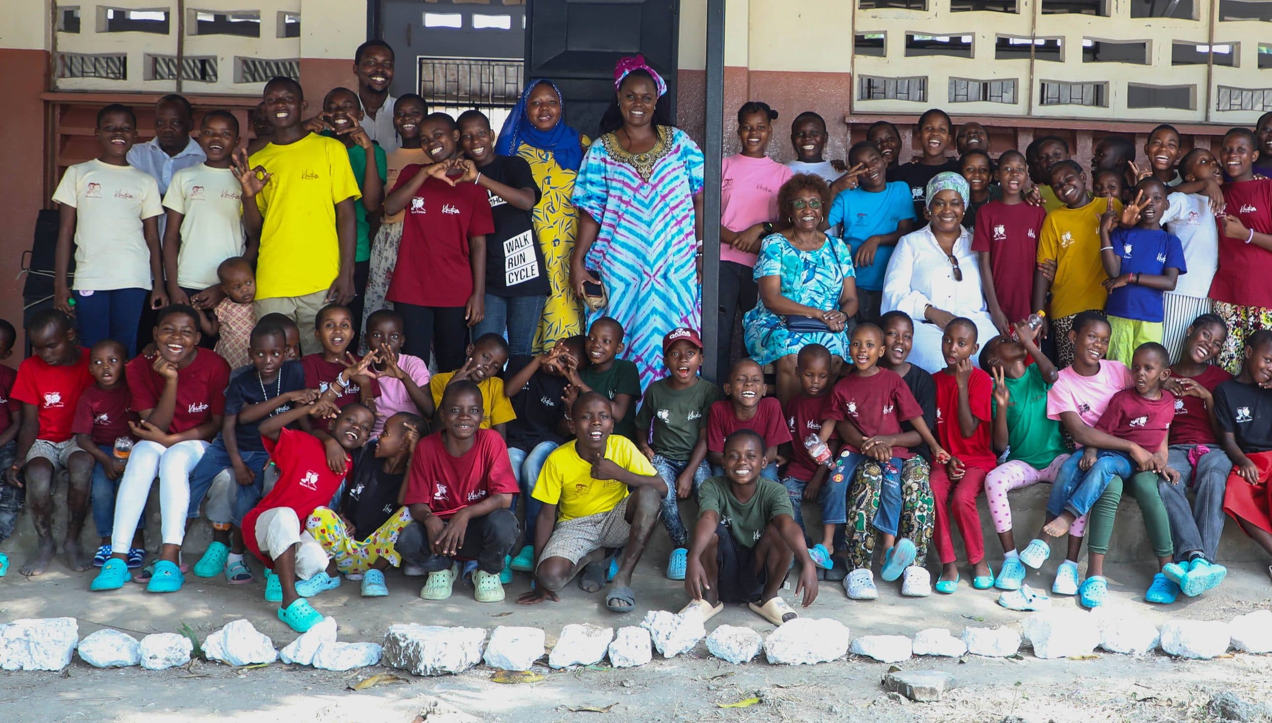 Wema Centre children, caregivers and leaders gathered together outside the centre
